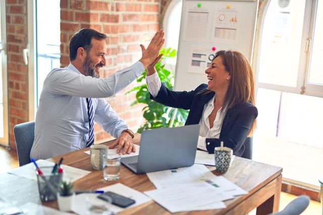 customer success managers laughing at work