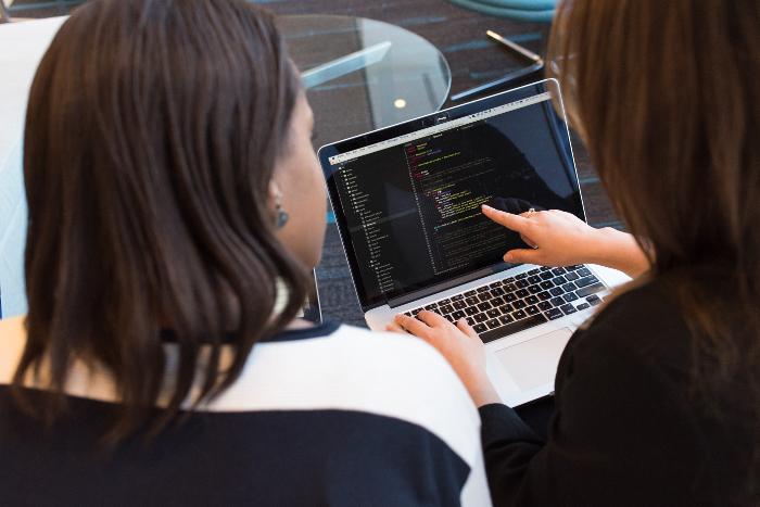 two abap developers working on a laptop