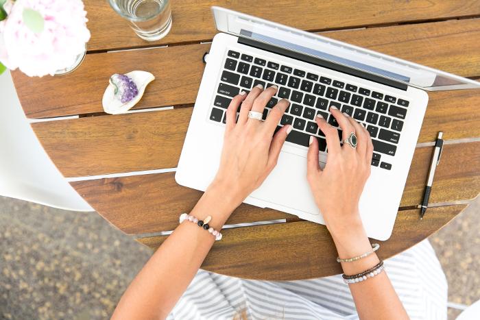 technical writer writing an article on a laptop
