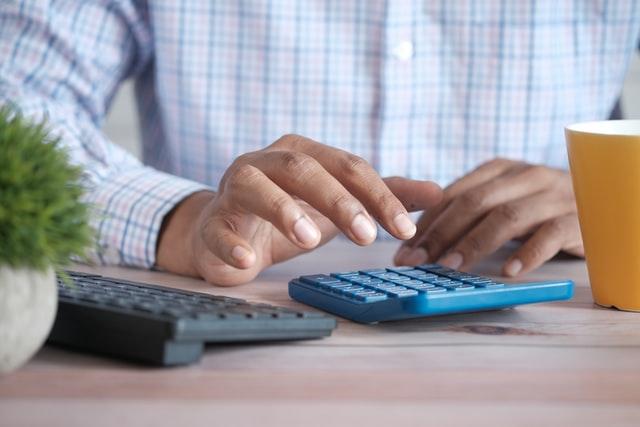 staff accountant using a calculator for work
