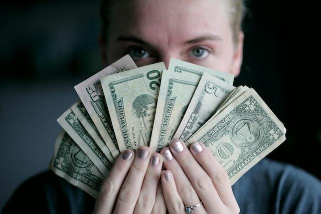 payroll analyst holding money
