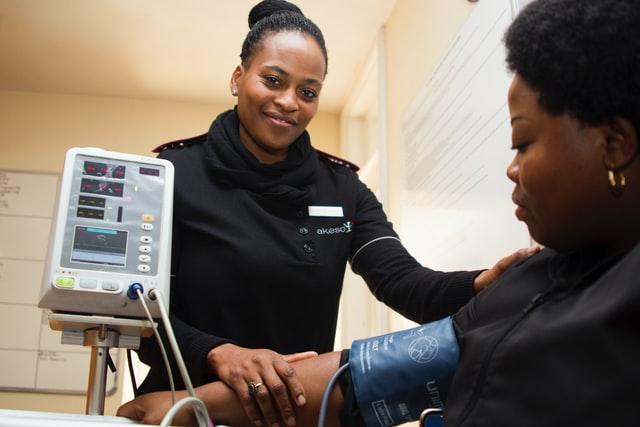 medical assistant helping a patient