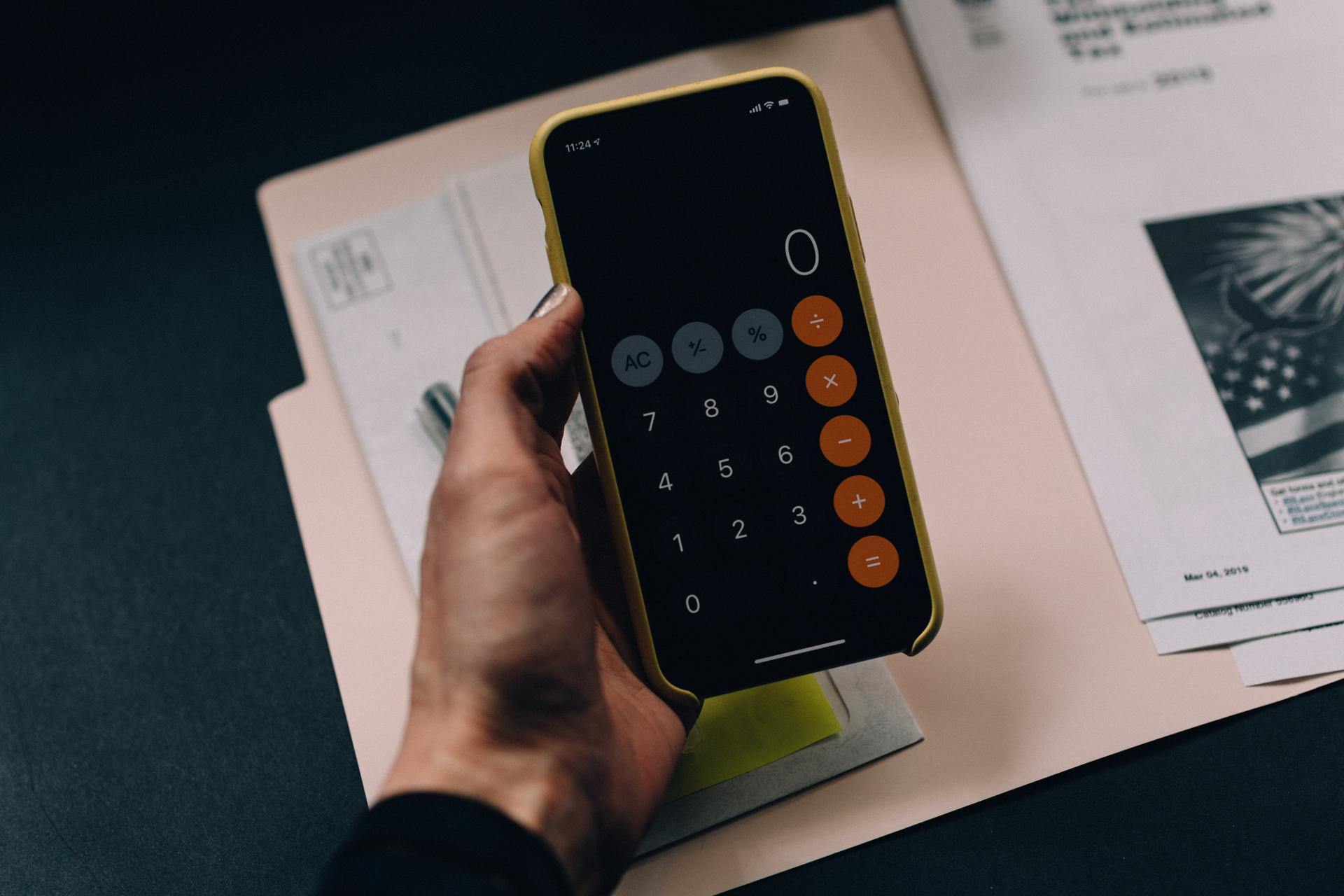 A person using a calculator to check bills